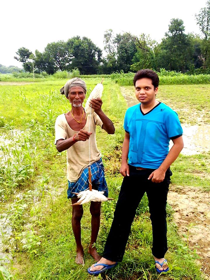 Indian farmer walking to work in the field
